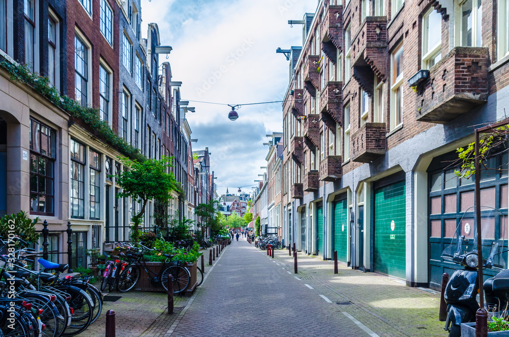 Beautiful alley alongside dutch houses in Amsterdam Netherlands