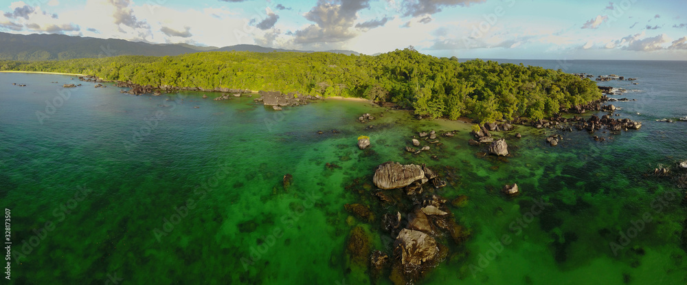 Pristine nature: Aerial drone panorama of untouched rainforest meeting the ocean / Masoala/ Madagascar