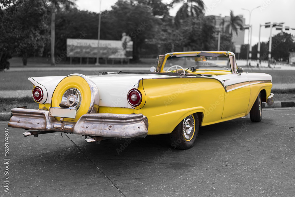 colorkey of yellow and white old american classic car with fin tails in havana - obrazy, fototapety, plakaty 