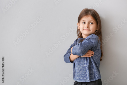 Fashionable little girl on grey background