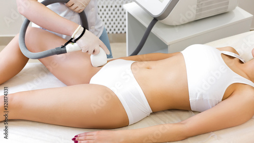 Laser hair removal on the skin of the legs. Epilation in a beauty parlor.