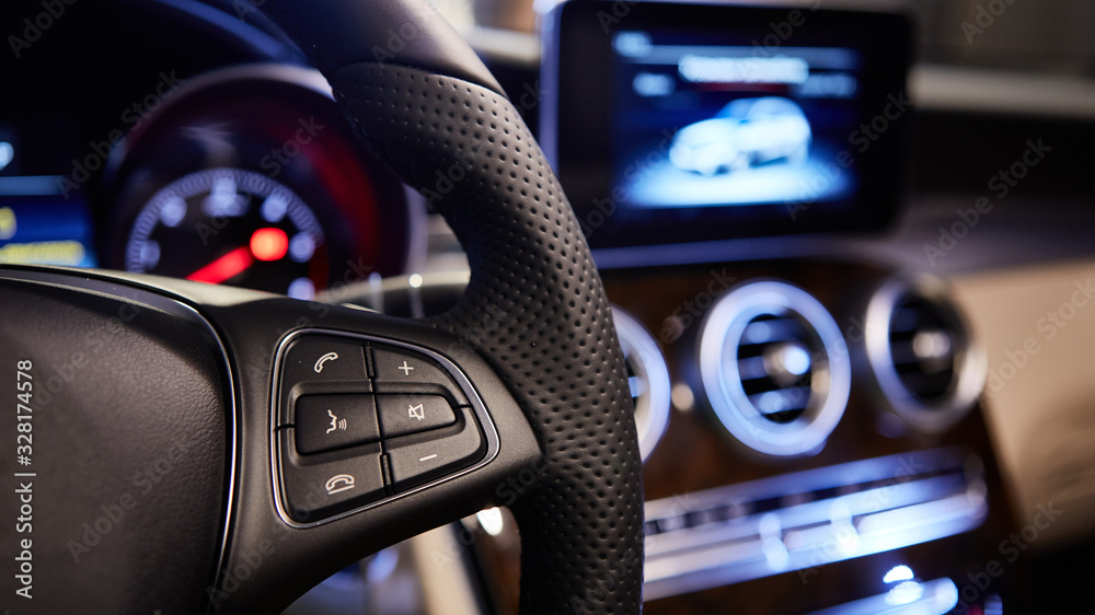 The cars multifunction steering wheel. Interior shot.