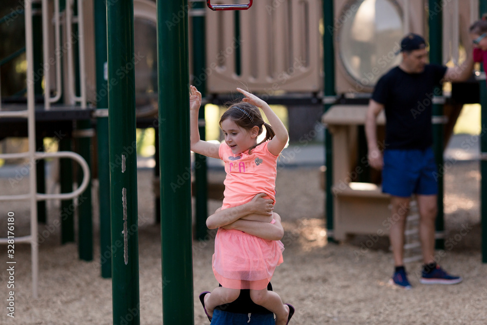Sisters are playing and using teamwork at the playground. Sisters are playing and using teamwork at the playground.