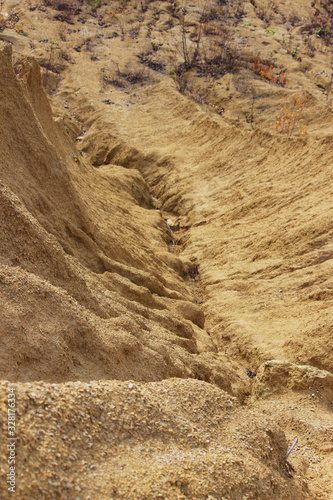 sand quarry. The crack between the two sand dunes is washed out by the rain