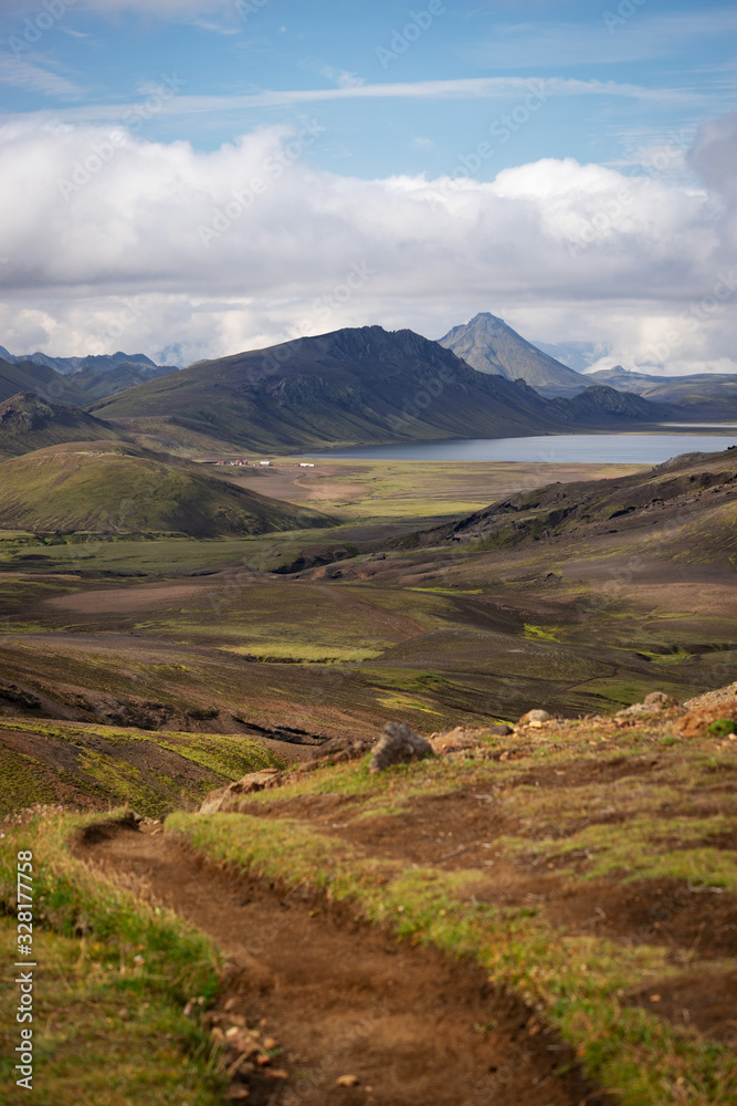 View mountain valley with green hills, river stream and lake. Laugavegur hiking trail, Iceland View mountain valley with green hills, river stream and lake. Laugavegur hiking trail, Iceland