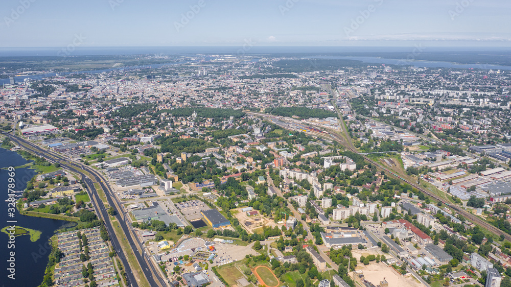 Aerial view photo from flying drone panoramic view of Riga's bridges, the Daugava River, the TV Tower and the city skyline on a sunny summer day in Riga, Latvia. (series)