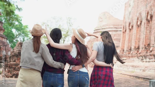 Behind group of Asian female tourist happy and joyful travel in Thailand.
