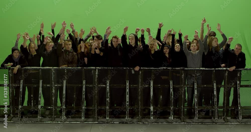 GREEN SCREEN CHROMA KEY Model released, Front view of huge crowd dancing and cheering at a concert or a show behind control barrier. Shot on RED Helium 8K Prores 4444
