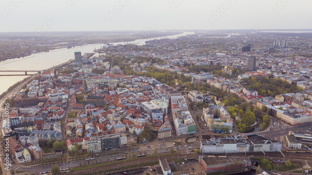Aerial view photo from flying drone panoramic half-kilometer view of Riga's bridges, the Daugava River, the TV Tower and the city skyline in Riga, Latvia. (series)