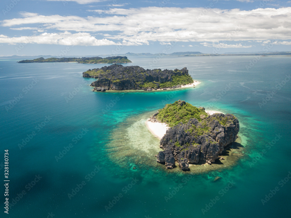 drone aerial panorama of pristine uninhabited island with untouched beach, corals andbizarre tsingy rock formation/ madagascar/ nosy hara