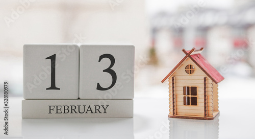 February calendar and toy home. Day 13 of month. Card message for print or remember