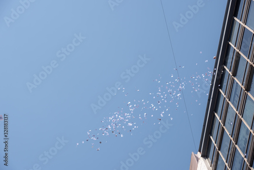 Buenos Aires, Argentina; December 10, 2019: A person throwing panflets from a roof of a building in the assumption of Alberto Fernandez as president photo