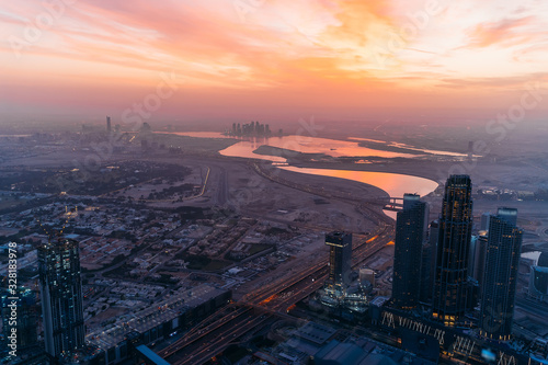 Beautiful sunrise above Dubai skyline, United Arab Emirates, aerial panoramic view from above from rooftop.
