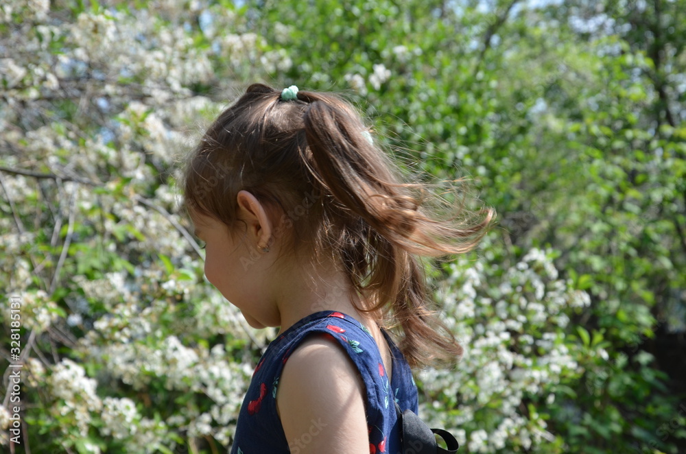A beautiful girl stands among the flowering trees. Lovely cute little girl in red sunglasses spring blooming garden a tree with white flowers. Happy childhood, the awakening of nature Portrait Romance A beautiful girl stands among the flowering trees. Lovely cute little girl in red sunglasses spring blooming garden a tree with white flowers. Happy childhood, the awakening of nature Portrait Romance