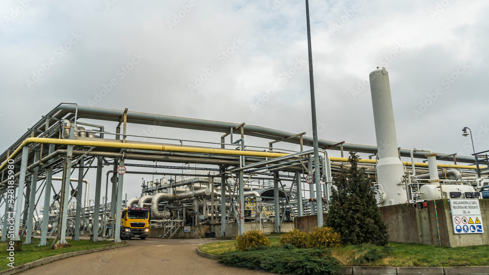 Panoramic view of the oil terminal with yellow tanker truck. Petrochemical concept. Panoramic view of the oil terminal with yellow tanker truck. Petrochemical concept.