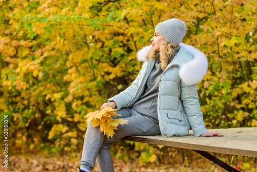 Clothes for rest. Girl relaxing in nature wearing knitwear suit and jacket. Model knitwear clothes leaves background. Feel practicality and comfort. Woman enjoy autumn season in park. Warm knitwear