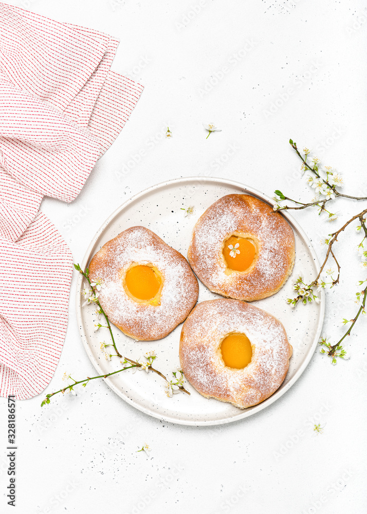 Homemade sweet easter buns with apricot and powdered sugar for breakfast. Top view. Copy space.