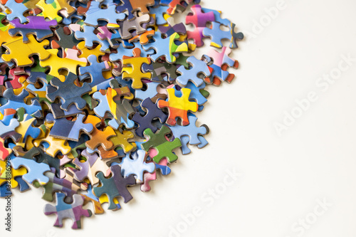 Isolated pieces of jigsaw puzzle on white table