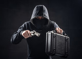 Man in black hoodie with gun. Bank robbery. Criminal drug dealer concept.