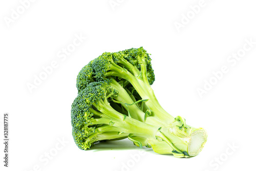 Broccoli on a white background. Eating vegetables and healthy nutrition. Consuming broccoli, adding to various dishes, diversifying food.