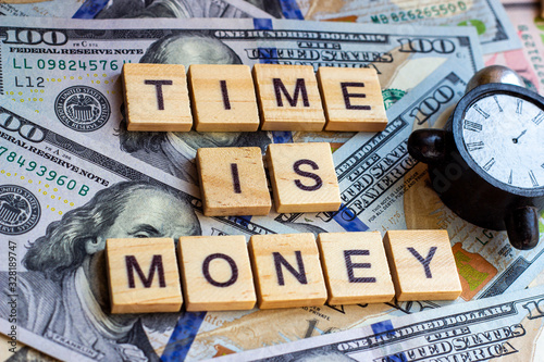 Words Time is Money as a proverb on dollar usa background with black and white clock © KatMoy