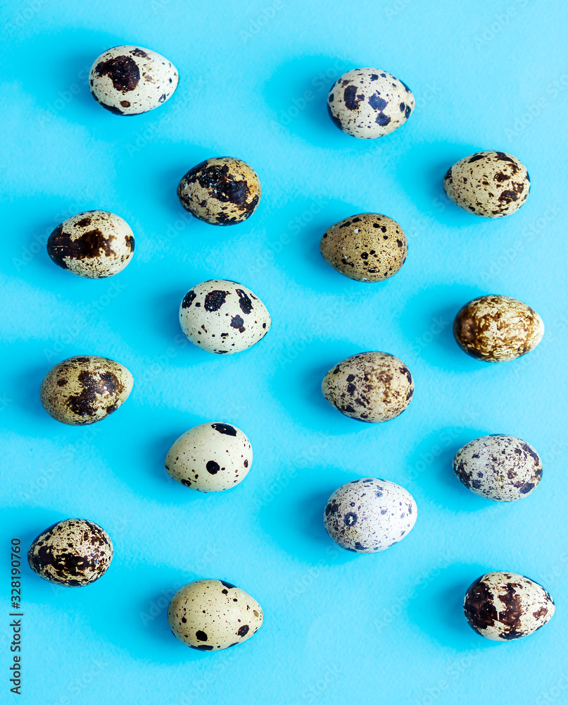 Quail eggs pattern on a blue background. 