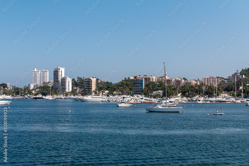view of city of Acapulco, sea view, boats and sun