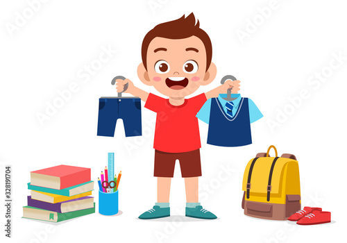 happy cute little kid boy preparing uniform for school