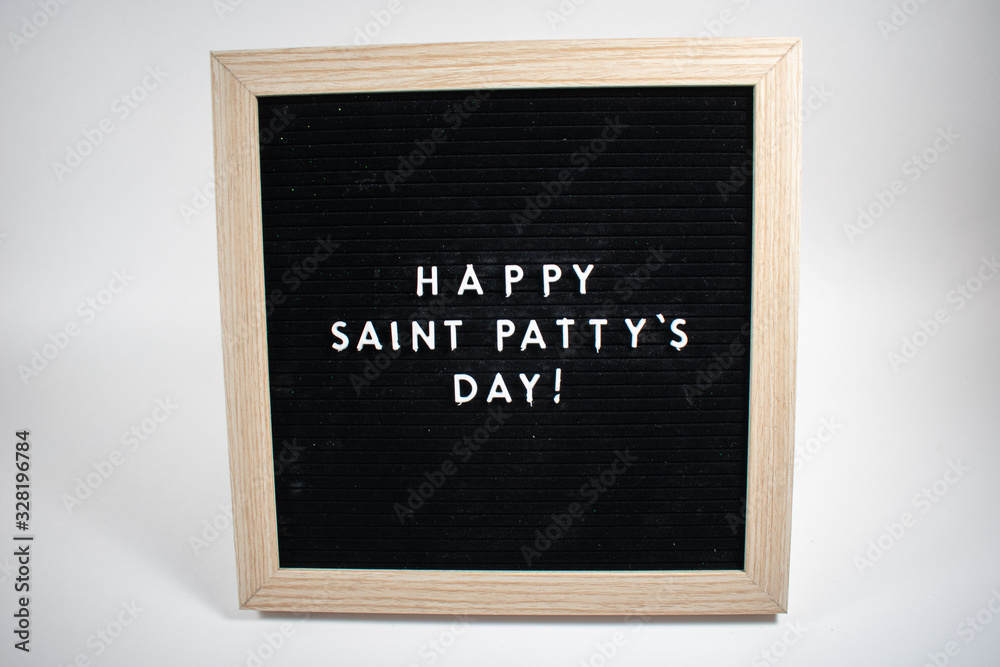 A Black Sign With White Letters That Says Happy Saint Patty's Day on a White Background