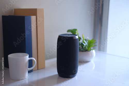 Close up of smart speaker on table against wall 