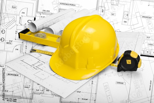 Worker helmet and drawing architecture or construction blueprint