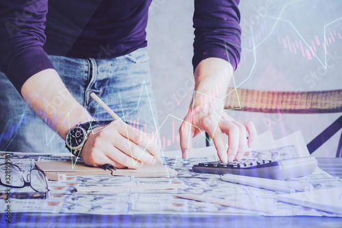 Multi exposure of man standing and planing investment with stock market forex chart.