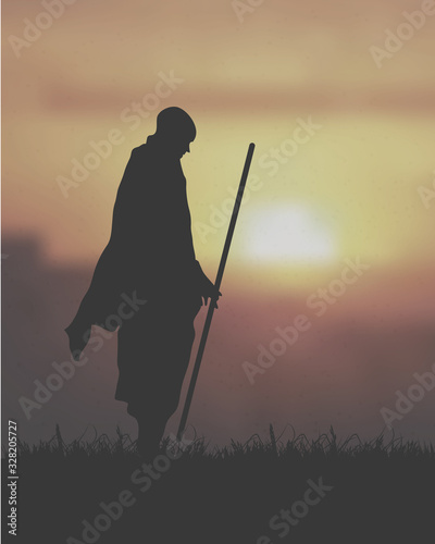 Fototapet An Asian Monk Holding The Club Under The Sunset