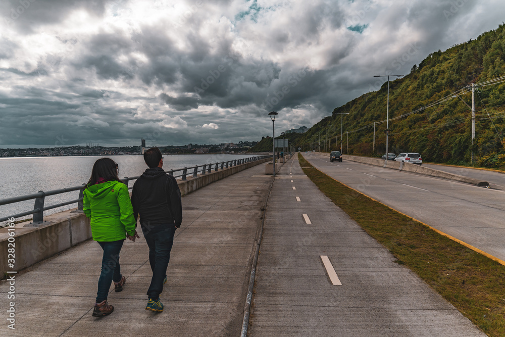  couple walks along waterfront