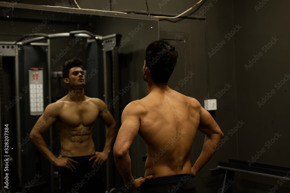 An young and handsome Indian Bengali man and his mirror image