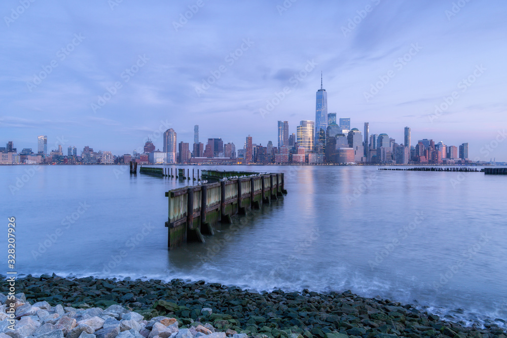 View on Financial District from Hudson River Pier during sunrise with long exposure
