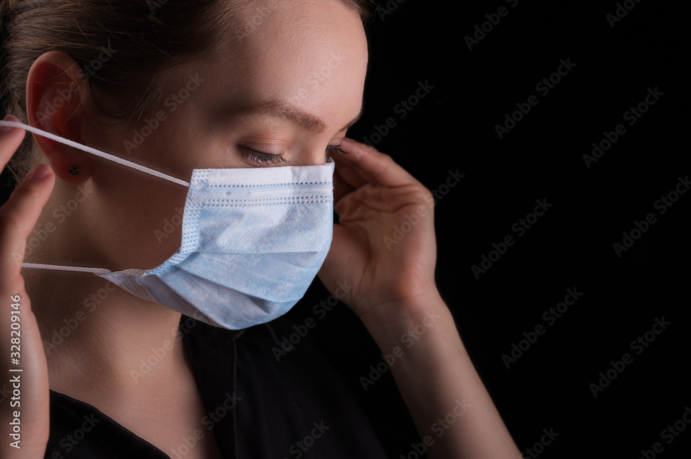 Girl in a mask, protection against coronavirus 2020, epidemic from China, mass quarantines. news Girl in a mask, protection against coronavirus 2020, epidemic from China, mass quarantines. news