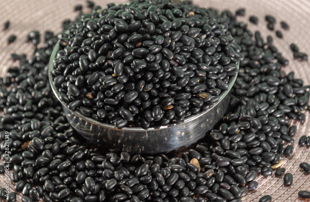 Metal casserole with beans grains on an opaque background
