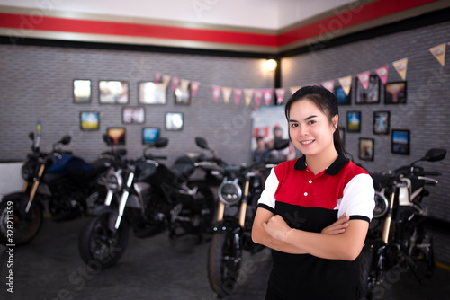 Professional female salesman at a motorcycle dealer in a sales showroom in Asia.