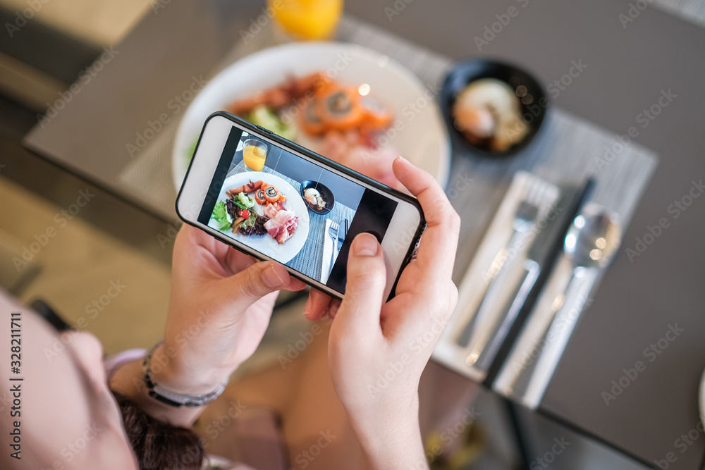 girl taking food photo with phone camera