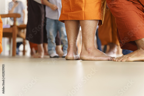 Thai Buddhist monk changing ritual cloth