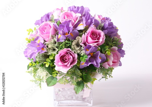 Colorful flower arrangement centerpiece in square glass vase