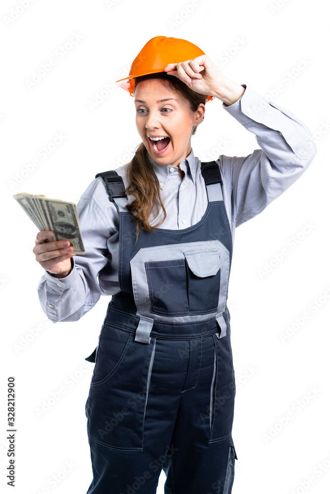 Builder engineer girl with money in her hand rejoices in so many dollars. Isolated Builder engineer girl with money in her hand rejoices in so many dollars. Isolated