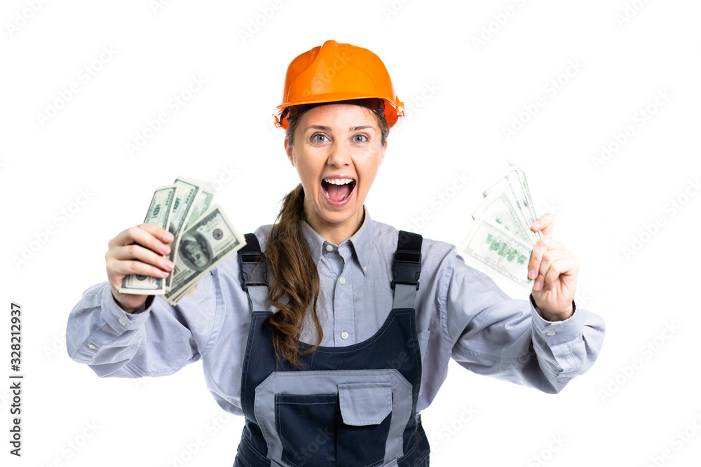 Builder engineer girl with money in her hand rejoices in so many dollars. Isolated Builder engineer girl with money in her hand rejoices in so many dollars. Isolated