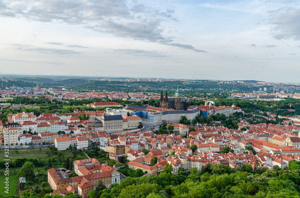 Orange color roof houses with St Vitus Cathedral in the background in Prague Czech Republic