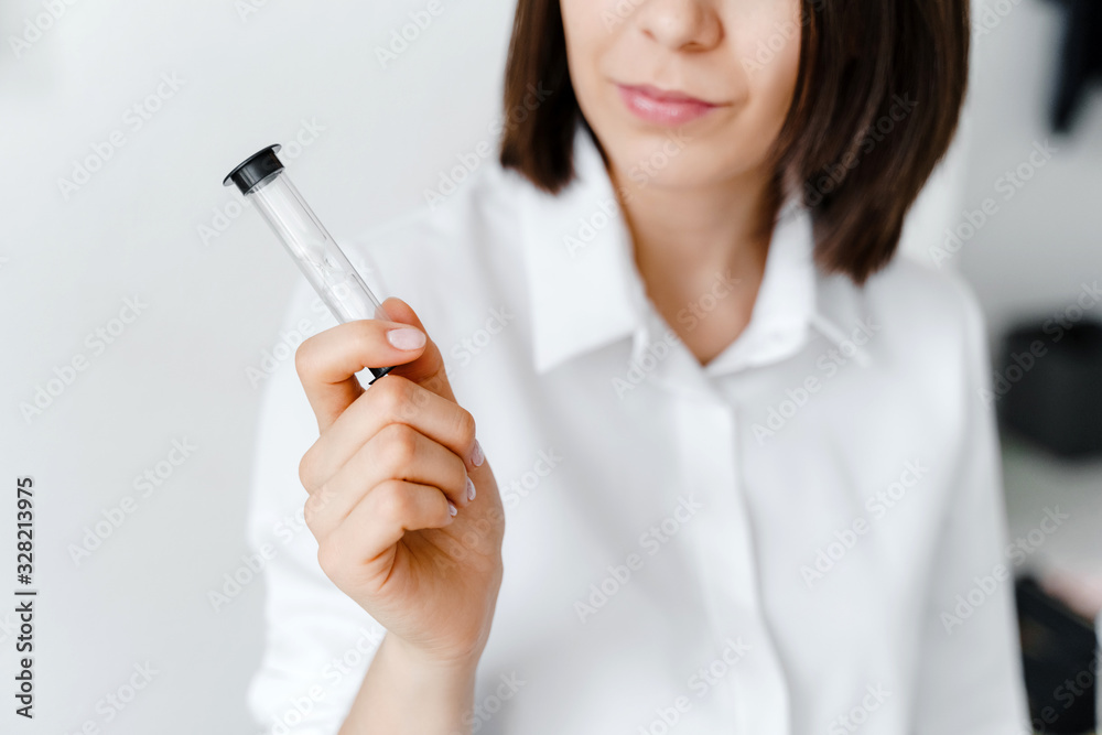 Woman holding in hand hourglass. Business, psychology and coaching concept.