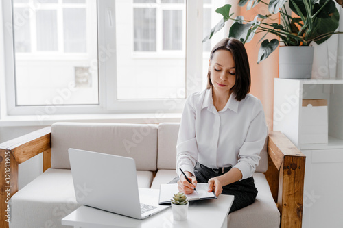 Young businesswoman working in office or at home. Business, work from home and freelance concept.