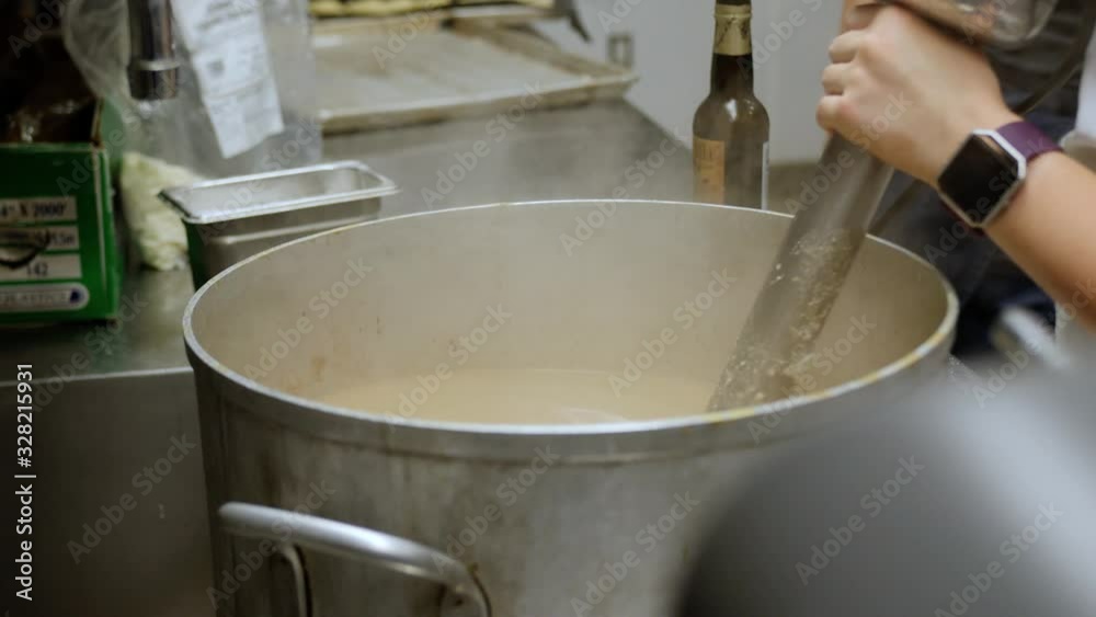 Restaurant Worker Stirs Huge Steaming Pot with Industrial Mixer, 4k Restaurant Worker Stirs Huge Steaming Pot with Industrial Mixer, 4k