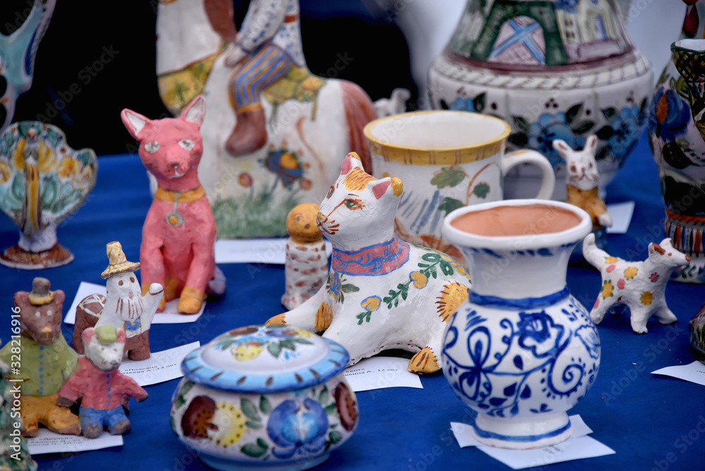 Exhibition sale of handmade clay figures made by children .Handmade pottery. Souvenirs.