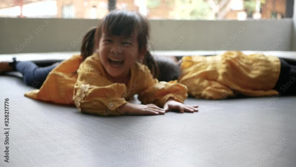 Adorable little child girl having fun to play on trampoline in playground. Concept of happy family and childhood. Adorable little child girl having fun to play on trampoline in playground. Concept of happy family and childhood.